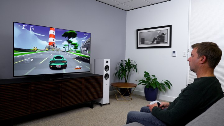 Sony PlayStation 5 कंट्रोलर का उपयोग करके Apple TV 4K पर मोबाइल कार रेसिंग गेम खेलना।
