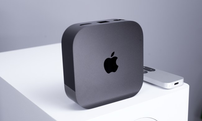 The Apple TV 4K standing vertically with the Apple logo showing from the front