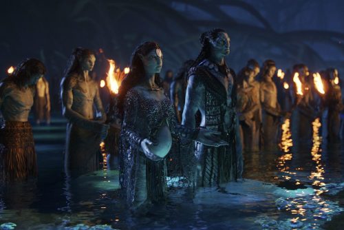 Two Na'vi characters stand in the water in a scene from Avatar: The Way of Water.