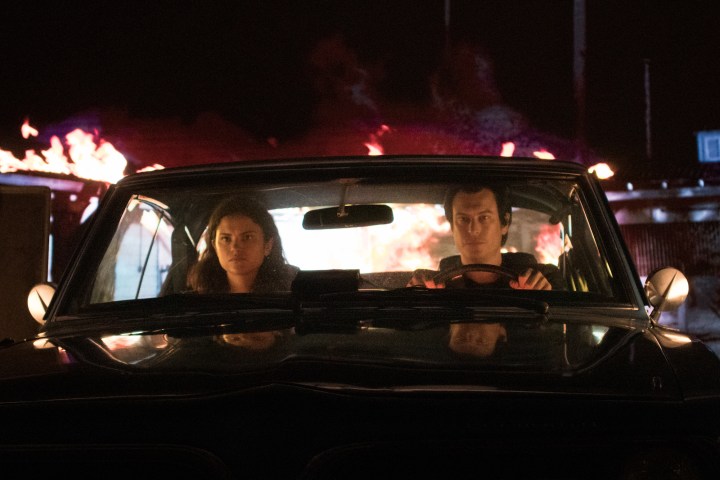 Two vampires sit in the front of a car in a scene from Blood Relatives.