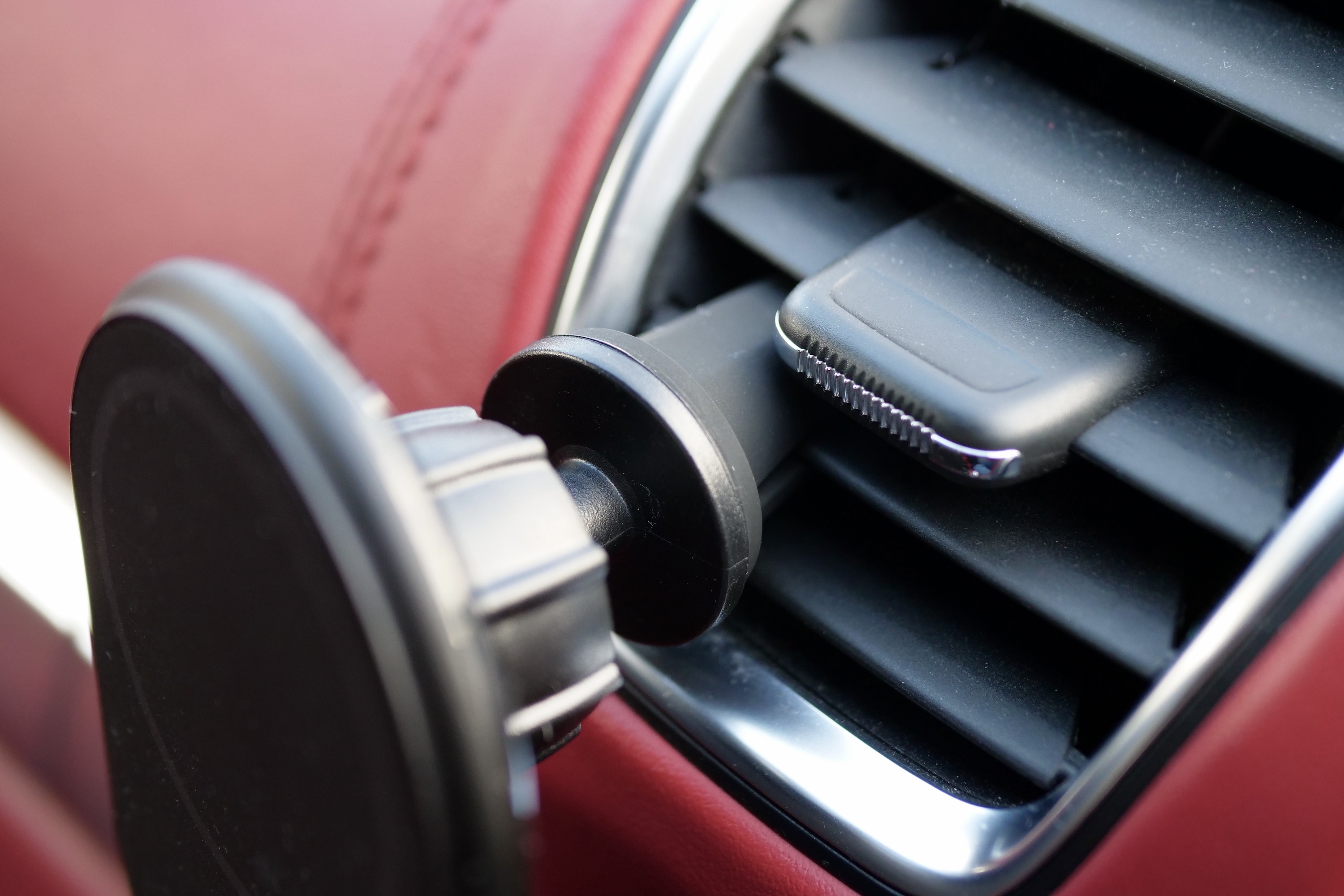 The top of the Belkin BoostCharge Magnetic Wireless Car Charger attached to an air vent.