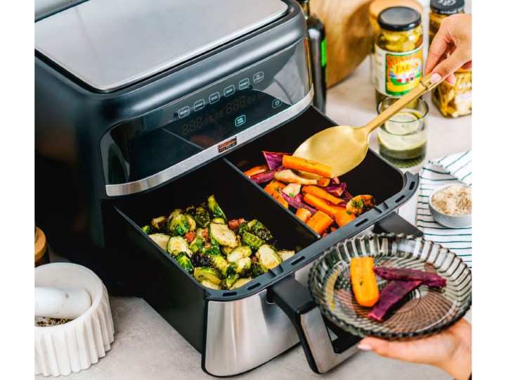Bella Pro Series 9-quart Digital Air Fryer with Dual Flex Basket with a variety of cooked foods.