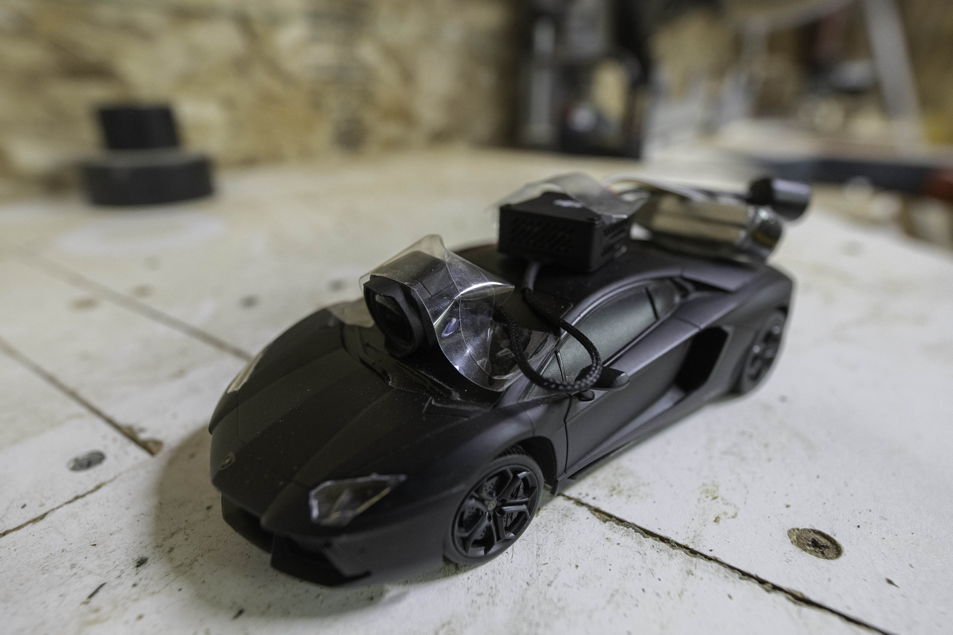 The DJI O3 Air Unit taped to the top of an RC Car.