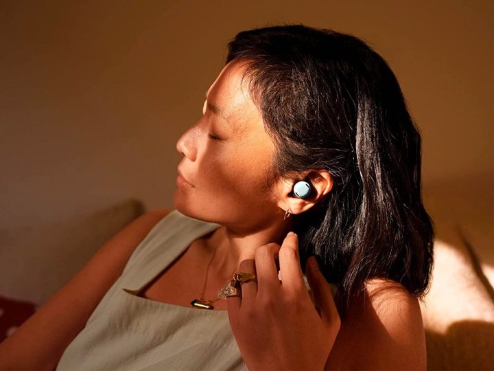 A woman relaxes with her Google Pixel Buds Pro.