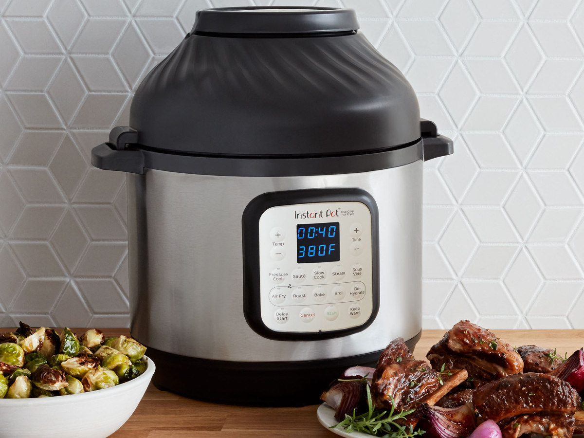 Instant Pot 6-quart Crisp Pressure Cooker Air Fryer em um balcão com carne cozida e vegetais.