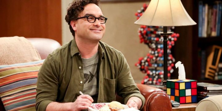 Leonard enjoys some take out on his couch in The Big Bang Theory