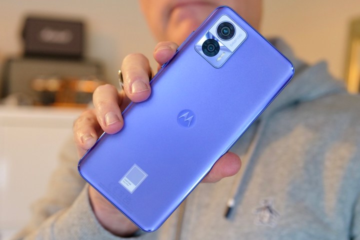 The Motorola Edge 30 Neo being held in a person's hand.
