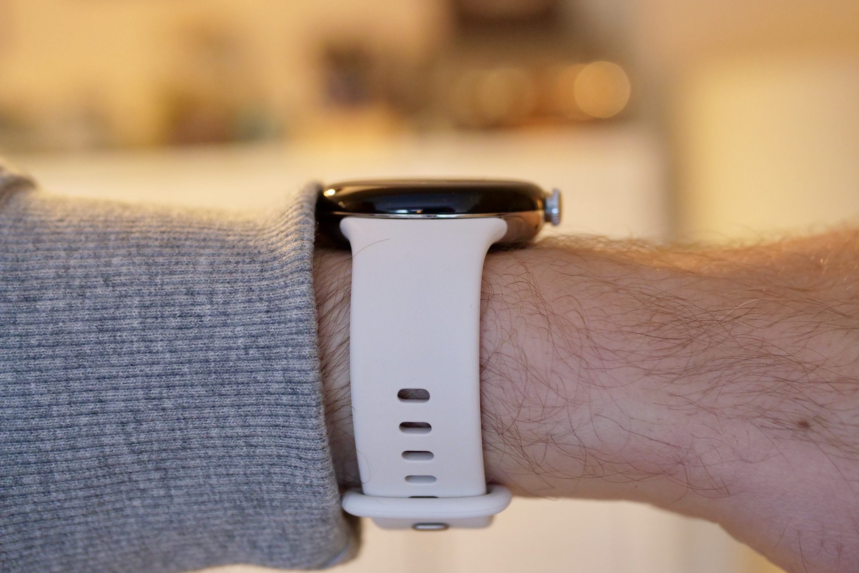 The side of the Pixel Watch on a person's wrist.