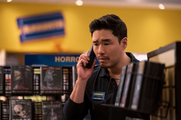 Randall Park holds a phone to his ear in Netflix's Blockbuster.