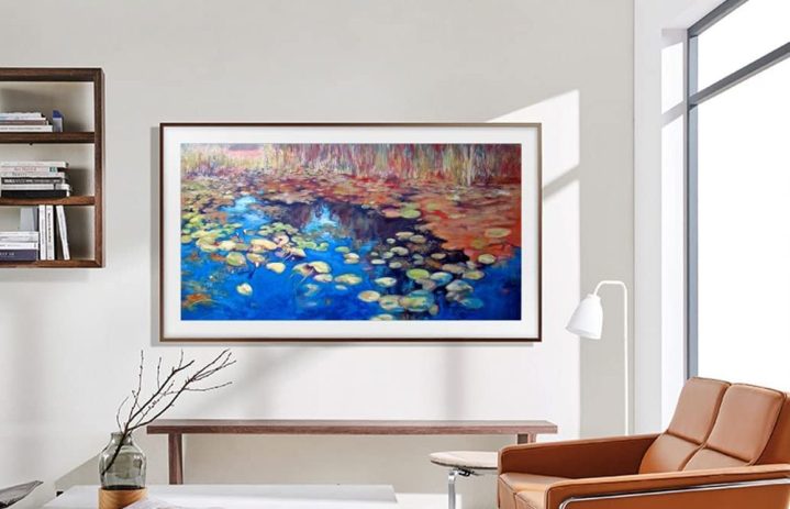 SAMSUNG QLED 4K LS03B Assortment The Frame Tremendous TV on living room wall showing a nature scene.