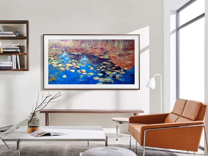 SAMSUNG 55-Inch Class QLED 4K LS03B Series The Frame Smart TV on living room wall showing a nature scene.
