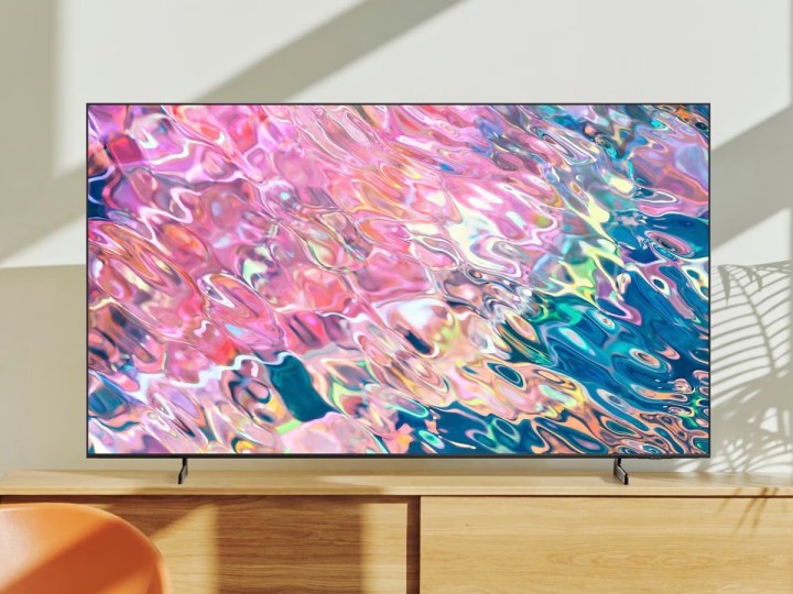 The Samsung Q60B QLED 4K Tizen TV sitting on a TV stand.