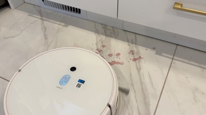 Yeedi mop approaching a red wine stain.