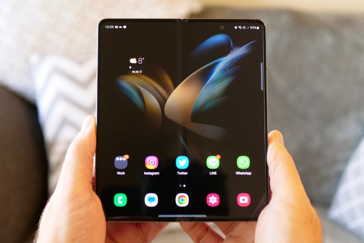 Galaxy Z Fold 4 unfolds in a person's hands.
