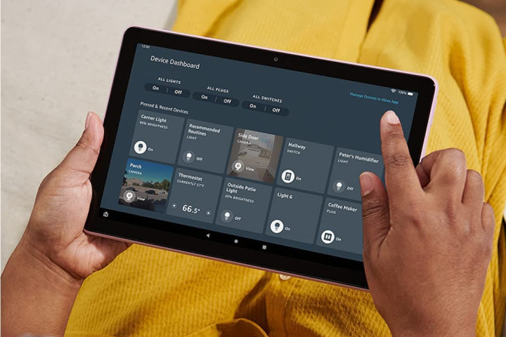A person wearing yellow uses the Device Dashboard on their Amazon Fire HD 10 tablet.