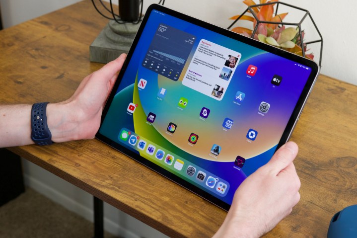 Someone holding the 12.9-inch version of the iPad Pro (2022).