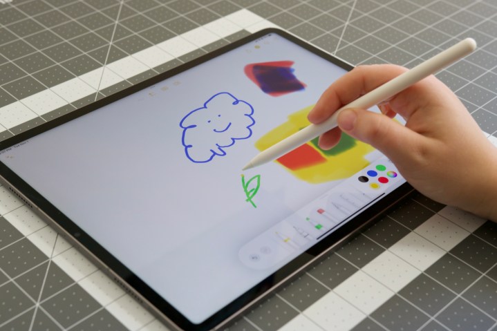 Drawing with Apple Pencil on iPad Pro (2022).
