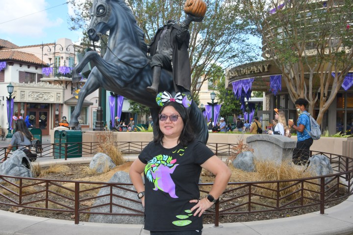 Christine poses in front of the Headless Horseman statue at DCA.