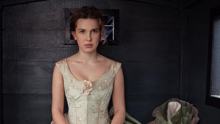 Millie Bobby Brown sits in a carriage in a scene from Enola Holmes 2.