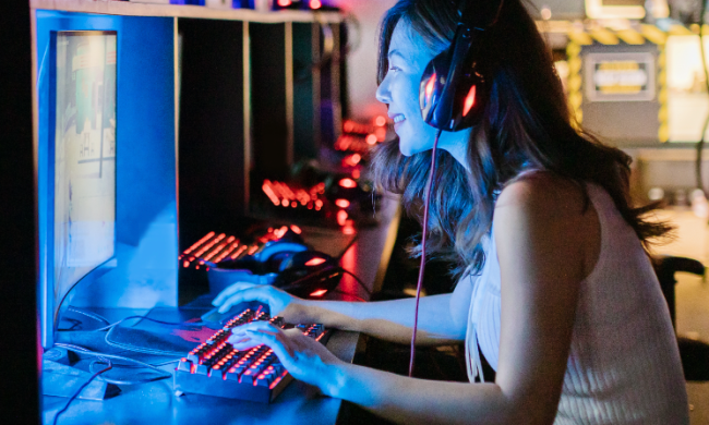 young woman playing video games on a PC