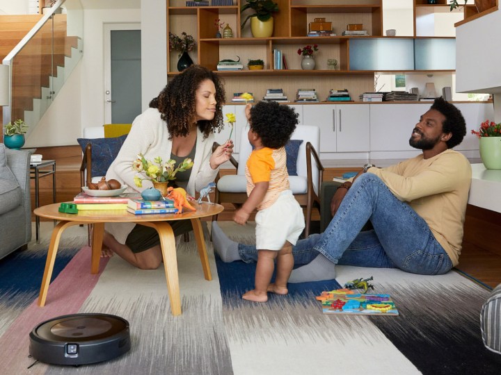 Family in great room with iRobot Roomba j7 (7150) Wi-Fi Connected Robot Vacuum.