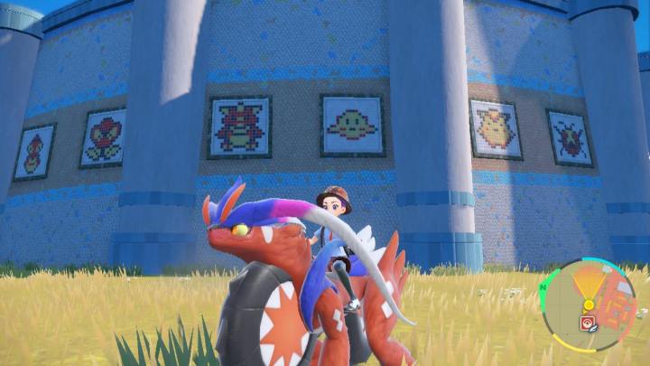 A Pokemon trainer sits in front of a mural that references Pokemon Red and Blue in Pokemon Scarlet.