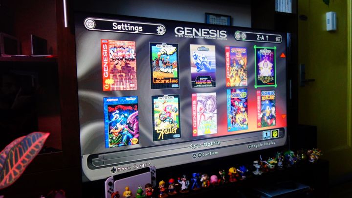 The game selection screen from a Sega Genesis Mini 2 appears on a TV.
