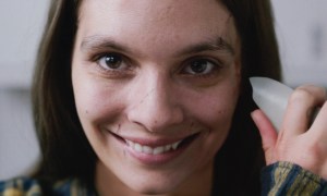 A woman smiles at the camera in Smile.