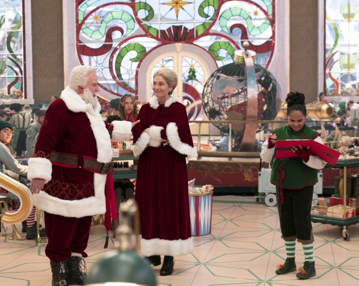 Tim allen and Elizabeth Mitchell as Santa Claus and Mrs. Claus stand in the toy factory in a scene from The Santa Clauses.