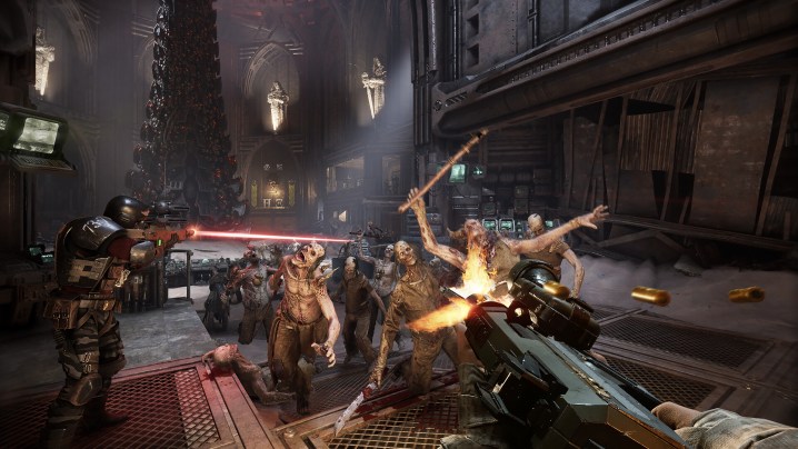 A horde rushing at the player in Warhammer 40K Darktide.