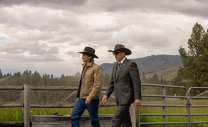 Two men walk on a ranch in Yellowstone.