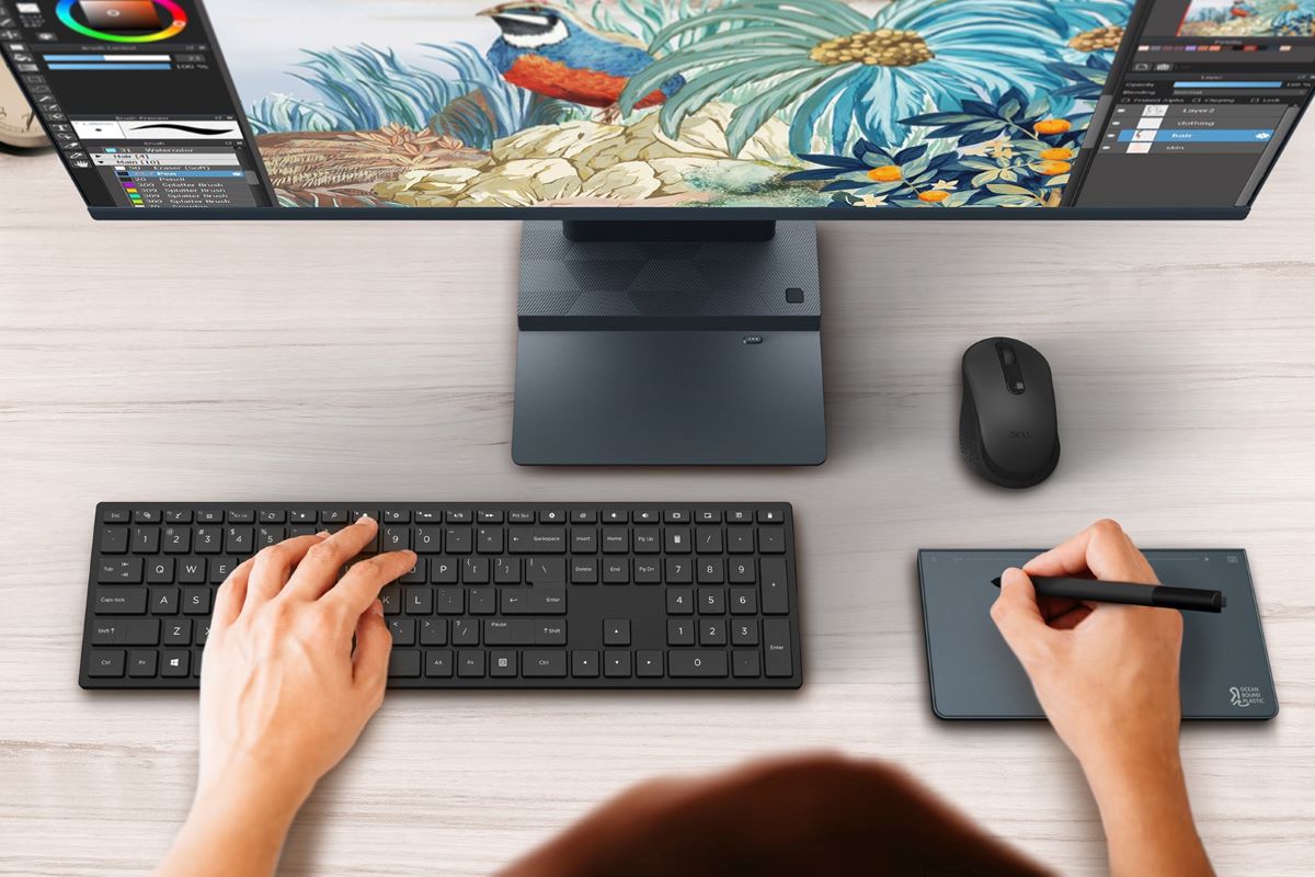A top-down view of the Aspire S 32 all-in-one with someone using the peripherals.