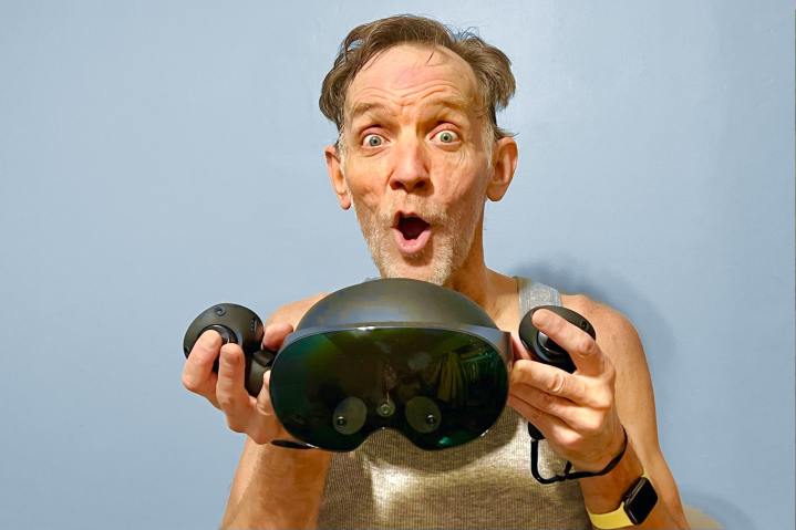 Alan Truly holds a Quest Pro while sweat drips after a VR workout.