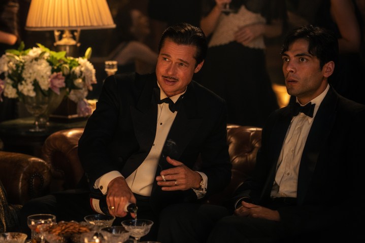 Brad Pitt sits with Diego Calva in Babylon.