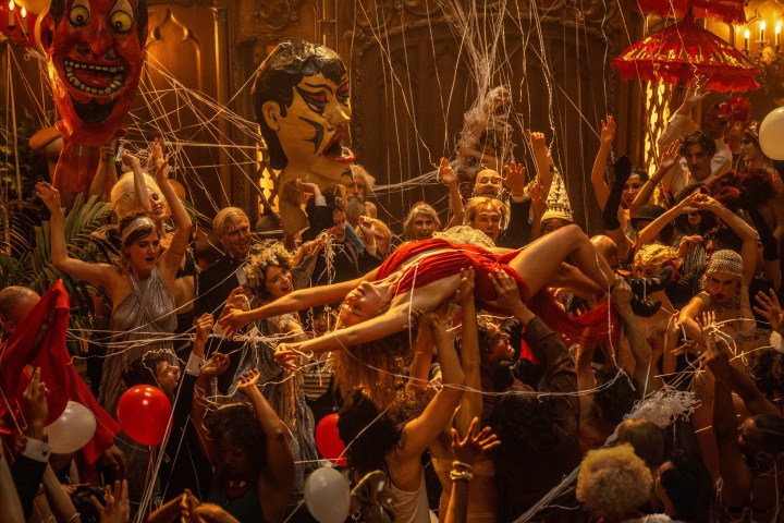 Margot Robbie crowd surfs at a party in Babylon.