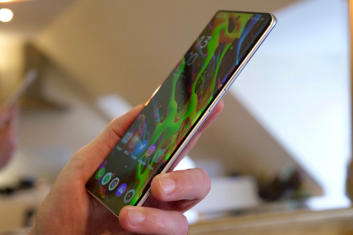 The side of the Realme 10 Pro Plus, held in a person's hand.