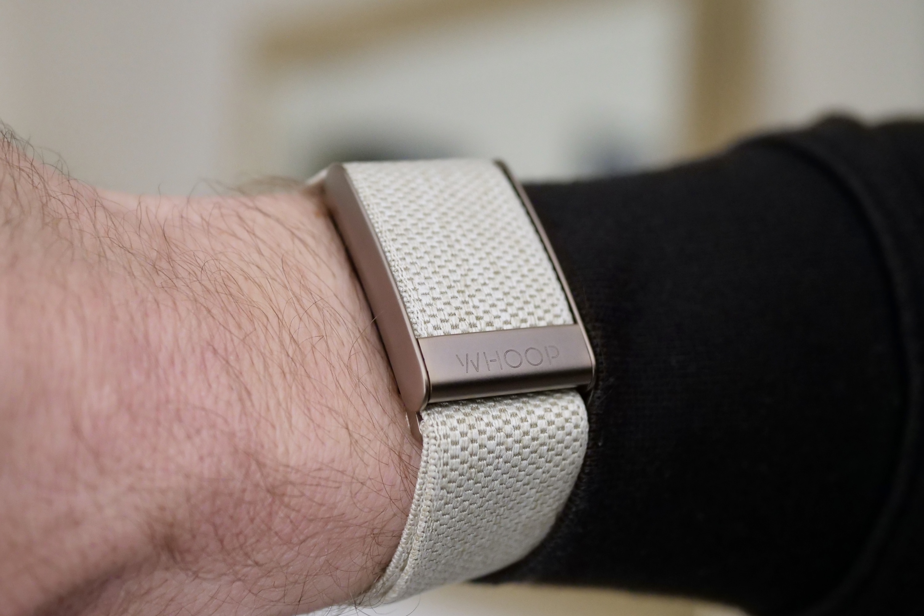 The front of the Whoop 4.0 on a person's wrist.