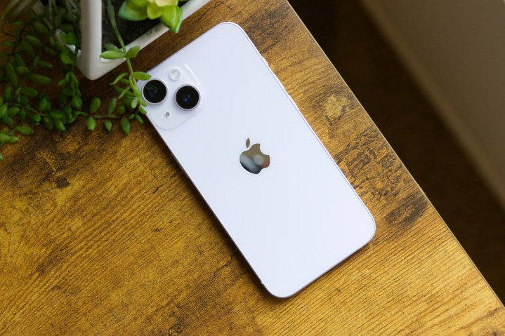 An iPhone 14 lying on a table.