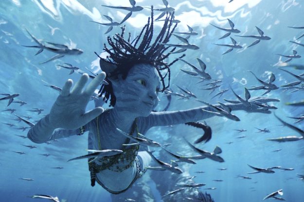 A blue-skinned Na'vi child swims underwater in a scene from Avatar: The Way of Water.