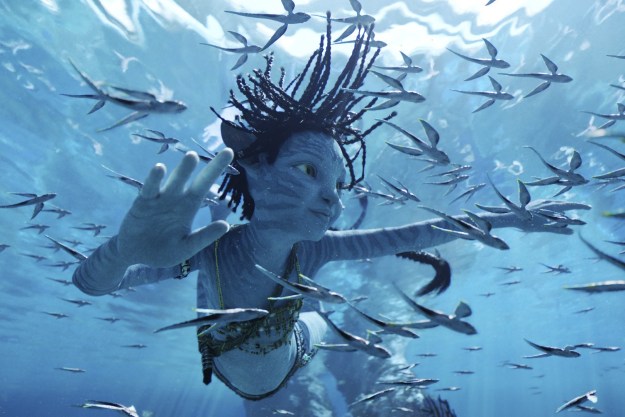 A blue-skinned Na'vi child swims underwater in a scene from Avatar: The Way of Water.
