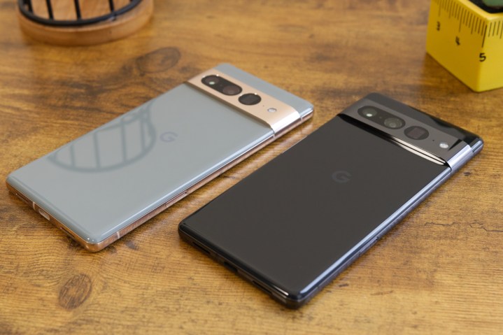 Two Google Pixel 7 Pro smartphones laying on a desk.