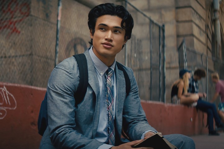 Charles Melton reads a book in The Sun is Also a Star.
