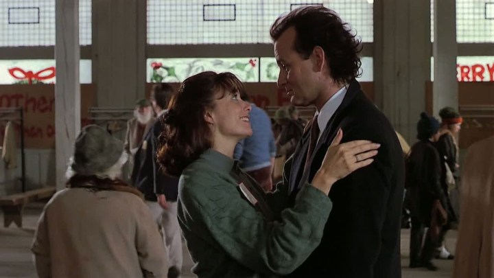 A mana and a woman embrace in Scrooged.