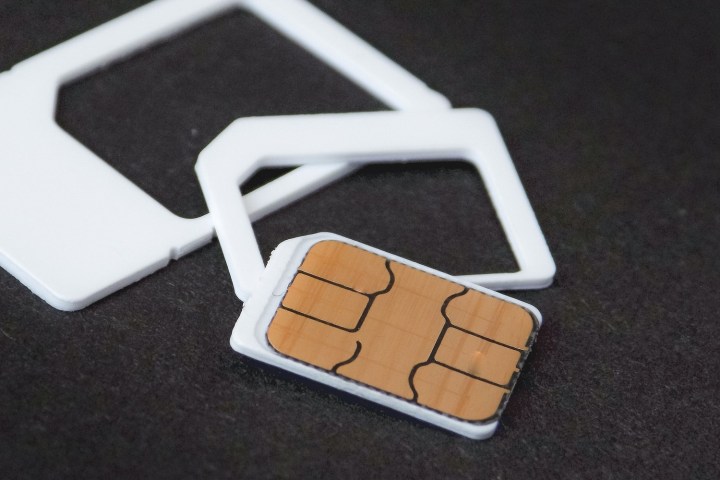 A SIM card outside its plastic tray.