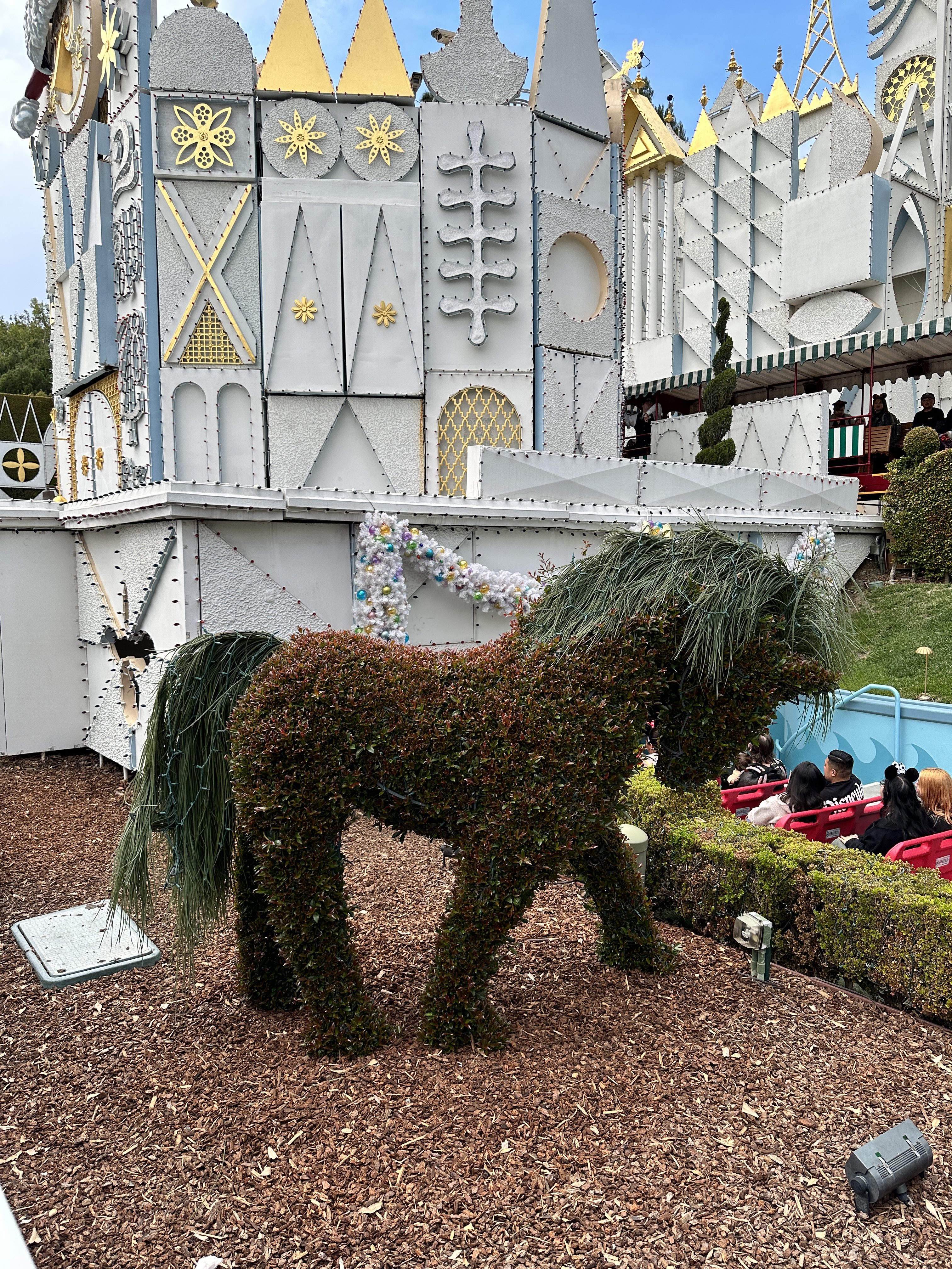 pony hedge at it's a small world holiday vibrant photographic style