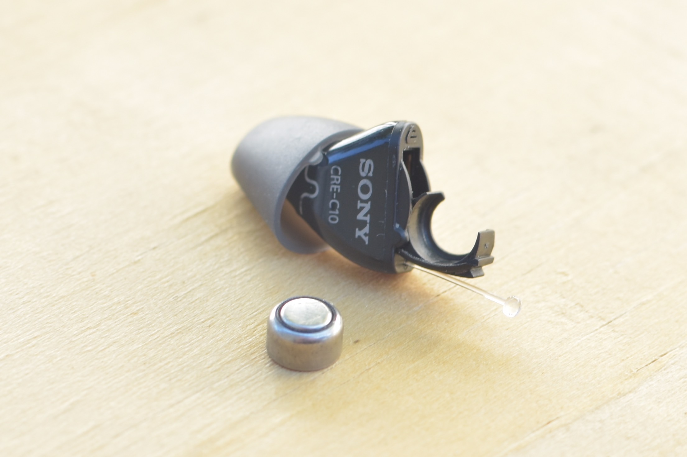 Sony CRE-C10 OTC hearing aid with battery removed.
