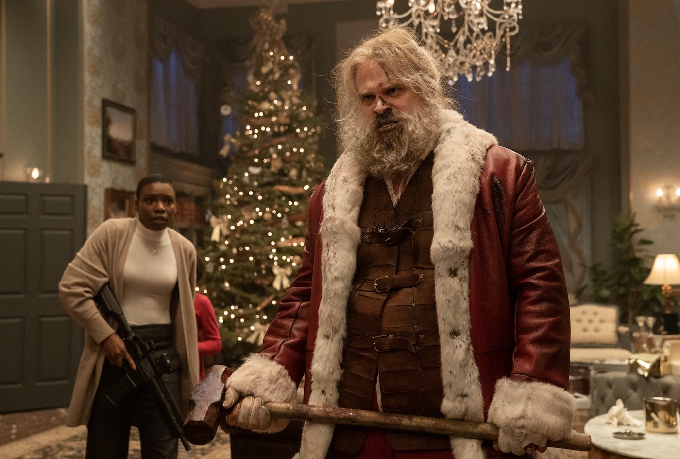 David Harbour dressed as Santa Claus, holding a sledgehammer.