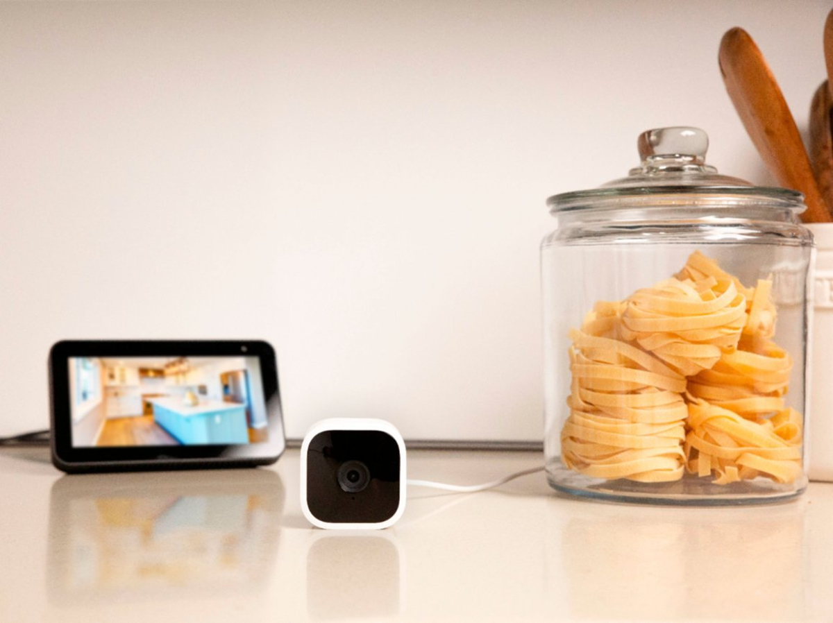 Blink Mini Indoor 1080p wireless security camera on a counter showing video capture on an Echo Show display.