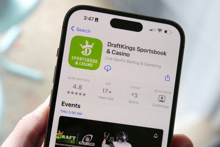 An iPhone 14 Pro, showing the DraftKings app in the App Store.
