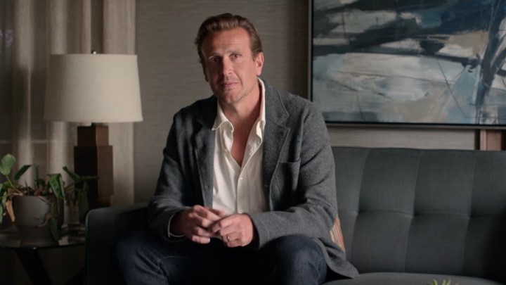 Jason Segal sits on a couch in Shrinking.